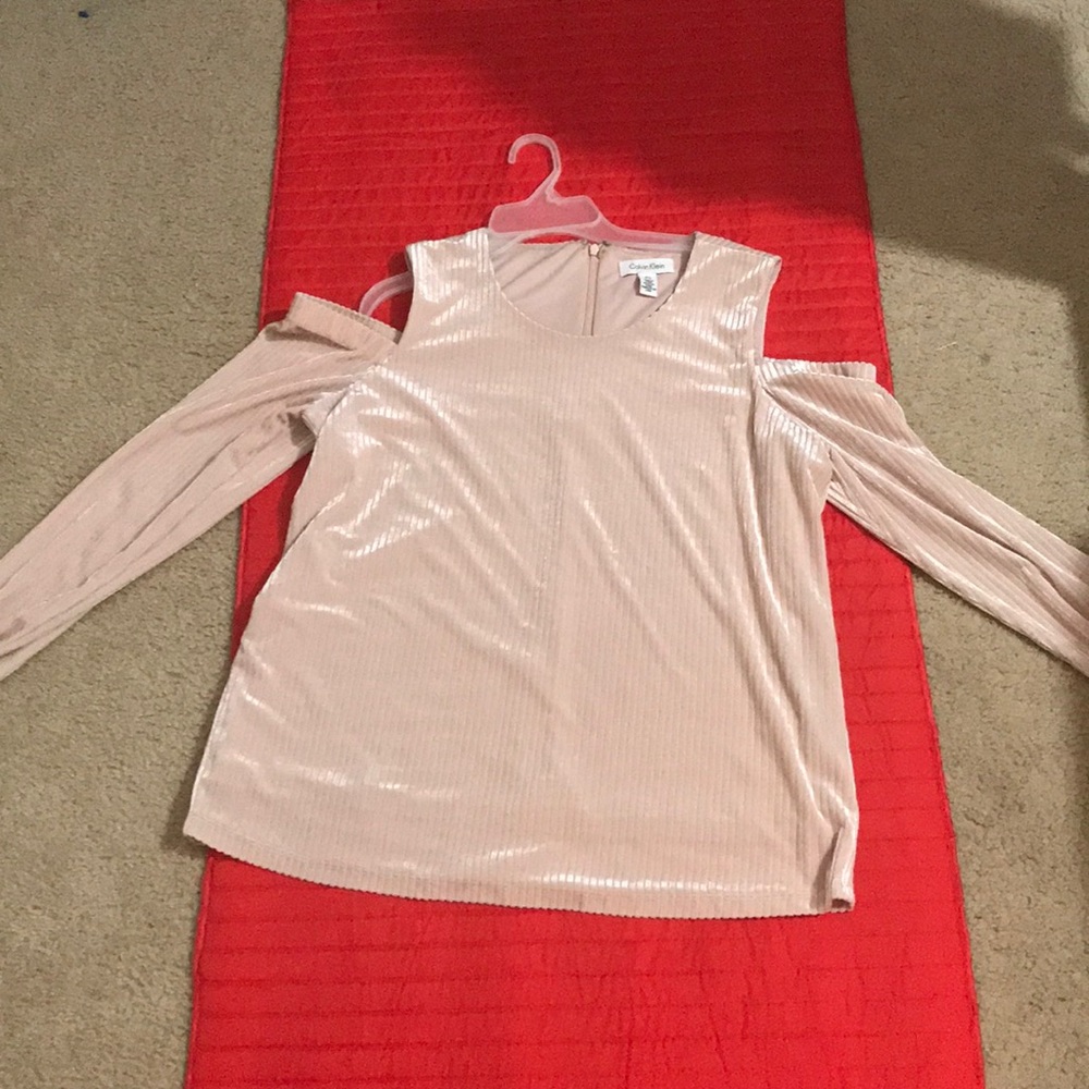 A pale pink long sleeve cold shoulder top